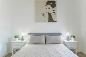a white bedroom with a bed with two night stands at Casa Jonas in Tías +13 photos