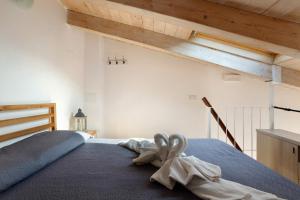 a bedroom with a bed with two towels on it at Il Giostro 1 Biassa in La Spezia