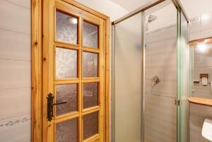 a bathroom with a shower and a glass door at Caratteristico e accogliente in Pila +15 photos