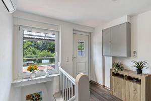 a white hallway with a staircase and a window at Ferienhaus Heidi in Bad Düben