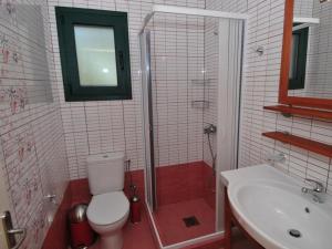 a bathroom with a toilet and a shower and a sink at Sami Beach Villas Fedra in Sami +22 photos