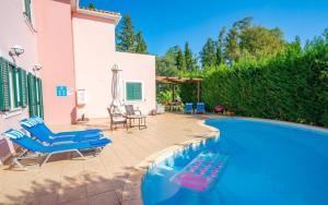 a swimming pool in a yard with a house at Sami Beach Villas Fedra in Sami