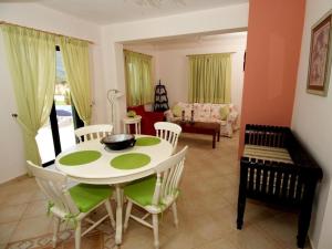 a dining room with a white table and chairs at Sami Beach Villas Fedra in Sami