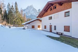 a house in the mountains in the snow at Ferienwohnung Sella Seis in Siusi