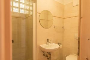 a bathroom with a sink and a shower and a mirror at Ferienwohnung Sella Seis in Siusi +15 photos