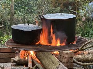 two pots and pans on top of a campfire at The SkyView Villa & Resort in Kệ Sơn