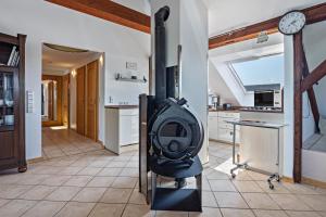 a kitchen with a stove in the middle of a room at Dachstübchen in Hagenburg