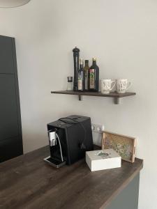 a kitchen counter with a toaster and bottles of alcohol at Design Apartment Flair u Komfort in Meschede