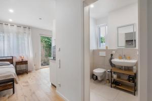 a white bathroom with a sink and a toilet at Global Bnb - Ay Homes in Augsburg +138 photos