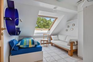 a living room with a couch and a window at Dachstübchen in Hagenburg