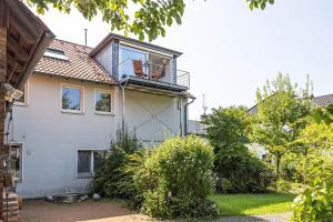 a house with a balcony on top of it at Dachstübchen in Hagenburg