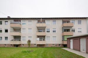 an apartment building with a yard in front of it at Business Apartment in Oberkochen in Oberkochen