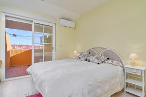 a bedroom with a large bed and a balcony at Casa Venus in Salobreña +26 photos