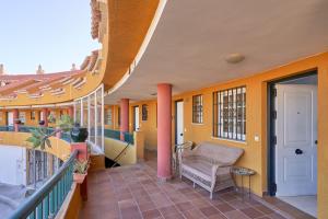 a balcony of a building with a chair on it at Casa Venus in Salobreña