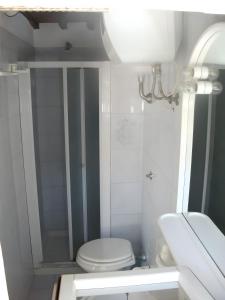 a white bathroom with a toilet and a sink at Ester Home Procchio Mare E Sole in Marciana