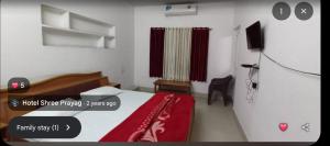 a bedroom with a bed with a red blanket at Hotel prayag with ev car station 7,4kw in Nāthdwāra