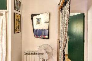 a hallway with a fan and a mirror at Casa en urb Cala Montgó in L'Escala