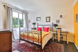 a bedroom with a bed with red pillows at Txori Etxea in Arcangues +21 photos