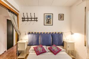 a bedroom with a bed and two night stands at Casa en urb Cala Montgó in L'Escala