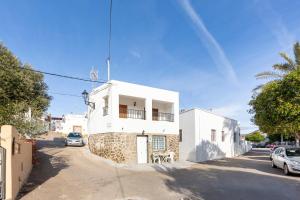 a rainbow in the sky above a white house at La Noria 3 in El Pozo de los Frailes +12 photos