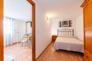 a bedroom with a bed and a desk and a table at La Noria 3 in El Pozo de los Frailes