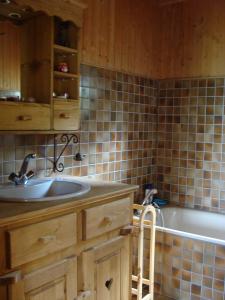 a bathroom with a sink and a bath tub at Chalet Jura in Doucier