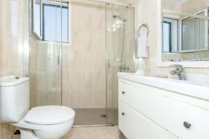 a bathroom with a toilet and a shower and a sink at Villa Goyo in Cala en Bosc +19 photos