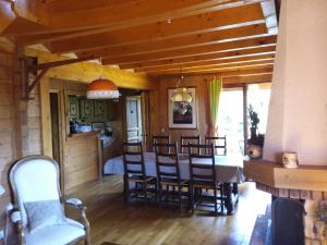 a dining room and kitchen with a table and chairs at Chalet Jura in Doucier