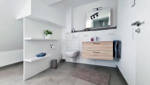 a white bathroom with a sink and a toilet at Adlerhorst in Baiersbronn +17 photos