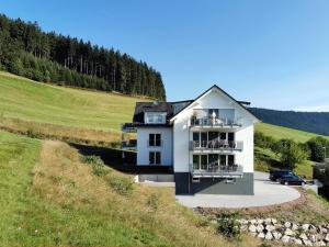 a house on a hill with a car parked in front at Adlerhorst in Baiersbronn