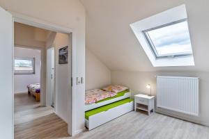 a small bedroom with a bed and a skylight at Leppert in Schwanau