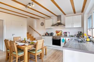 a kitchen with a table and chairs in a kitchen at Leppert in Schwanau