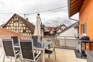 a patio with a table and chairs and an umbrella at Leppert in Schwanau