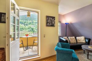 a living room with a couch and a table and a window at Ferienwohnung Saline in Bad Wildbad
