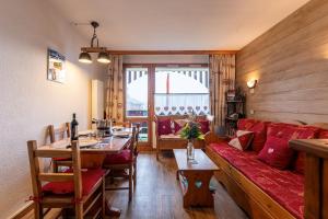 a living room with a couch and a table at Le cheval blanc E7 in Valmorel +30 photos