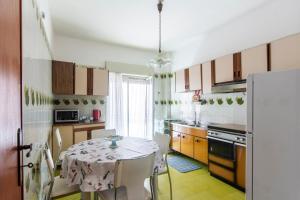 a kitchen with a table with a table cloth on it at Appartamento tra mare e montagna in Gaggi