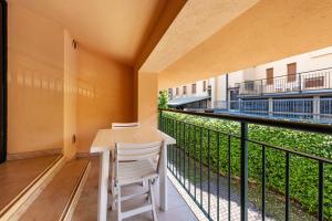 a balcony with a desk and a chair at Cozy studio Le Vele Garda Lake in Toscolano Maderno