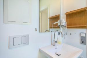 a bathroom with a sink and a mirror at Ferienhaus Im Tobel in Deggenhausertal +22 photos