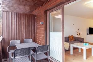 a room with a table and chairs and a couch at Haus Excelsior Top 30 in Seefeld in Tirol