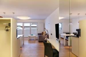 a living room and dining room with a kitchen and a living room at Haus Excelsior Top 30 in Seefeld in Tirol