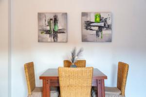 a dining room table with three pictures on the wall at Mccoy avenida 3 in Macael