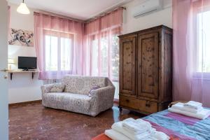 a bedroom with a chair and a cabinet and a bed at Art Rooms in Arezzo