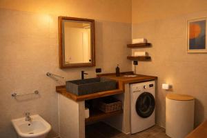 a bathroom with a sink and a washing machine at Central Penthouse Luino in Luino