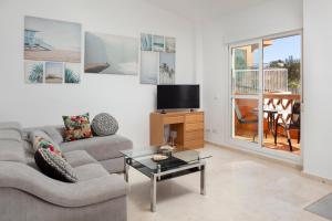 a living room with a couch and a table at Apartamento Baviera Golf 002 in Vélez-Málaga