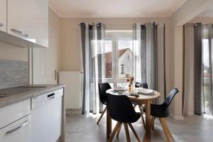 a kitchen with a table and chairs and a dining room at Sabines Ferienwohnung 2 in Glückstadt