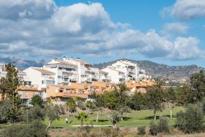 a group of buildings in a park with trees at Apartamento Baviera Golf 002 in Vélez-Málaga