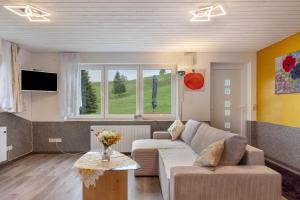 a living room with a couch and a table at Ferienwohnung im Grünen in Oberried