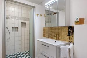 a bathroom with a sink and a shower at Ferienwohnung im Grünen in Oberried +22 photos