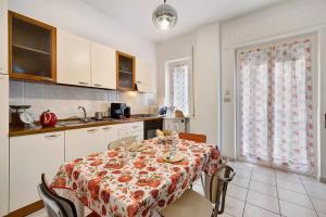 a kitchen with a table with a table cloth on it at Casa Rosso Melograno in Alassio +14 photos
