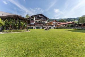 a large grass field in front of a building at Ferienwohnung Riepl in Schliersee